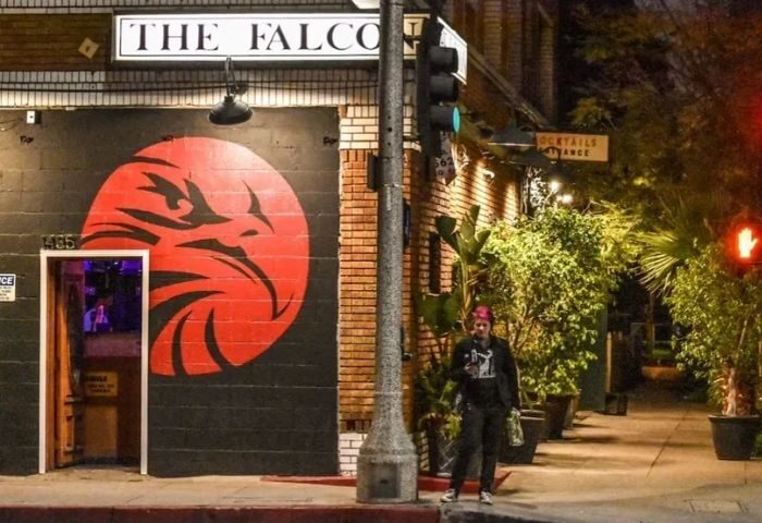 Falcon North location: The Falcon bar exterior with a red falcon logo. Gay travel advice for men, nightlife spot.