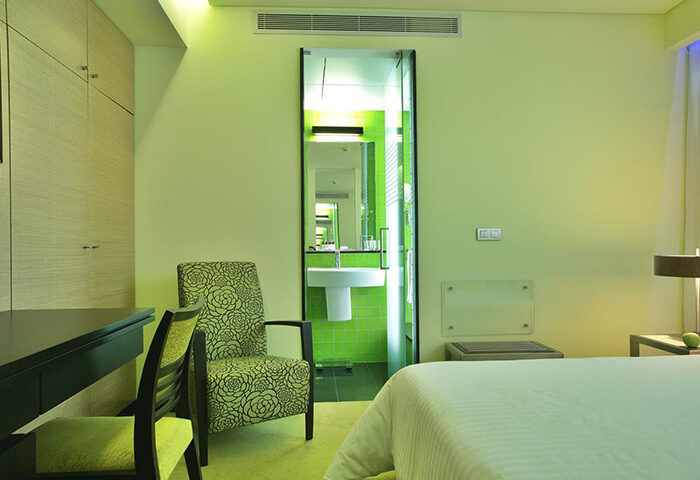 SANA Capitol Hotel room in Lisbon's gayborhood. Big room for 3 adults. See the bathroom with a sink and green tiles. LGBT+ friendly hotel.