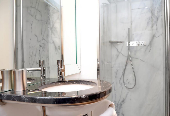 Browns Downtown Hotel bathroom. Marble shower, black sink, modern faucets. Gay-friendly hotel near Trombeta Bath, Lisbon.