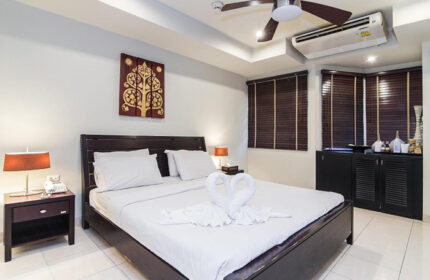 Copa Hotel room in Pattaya, Thailand. Find cheap gay hotel near gay nightlife. Bed with swan towels, ceiling fan, and air conditioning.