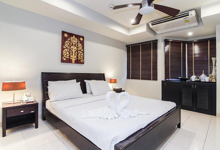 Copa Hotel room in Pattaya, Thailand. Find cheap gay hotel near gay nightlife. Bed with swan towels, ceiling fan, and air conditioning.