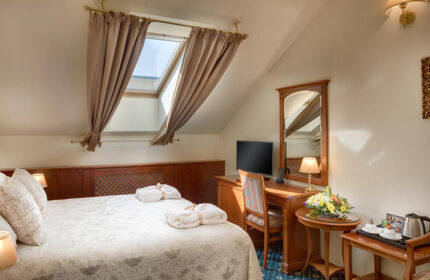 Boutique Hotel Seven Days room in Prague's gayborhood, Vinohrady. Cheap hotels for gay couples. Room with bed, desk, and skylight.