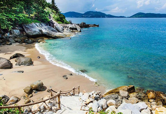 Beachfront view at U Zenmaya Phuket Resort. Find cheap, luxury gay hotels in Phuket. Tropical beach with clear blue water.