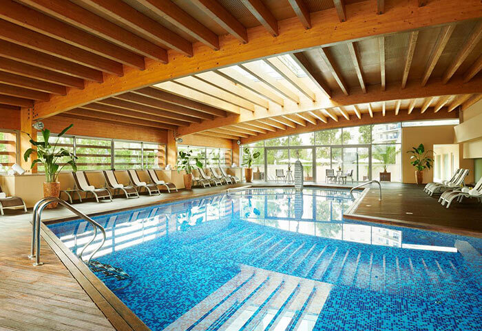 Corinthia Hotel Lisbon indoor pool. Find cheap luxury gay hotel in Lisbon for gay men travel. Relaxing pool and lounge chairs.