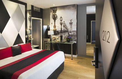 L'Empire Paris Hotel room in Marais gayborhood. Cheap luxury gay hotel with stylish decor, Paris bridge mural, and modern design. Room number 212.