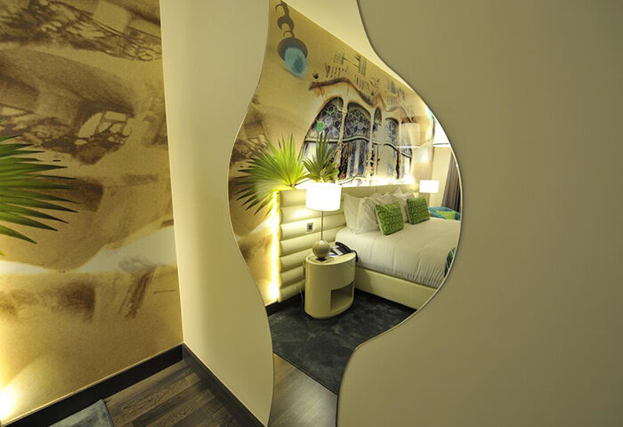 Hotel Indigo Barcelona Plaza Catalunya room view. Gay-friendly hotel near gayborhood, Barcelona. Cheap price room with bed, lamp, and Gaudí-inspired design.