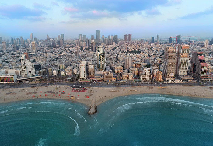 Tel Aviv skyline view from Isrotel Tower, near Hilton Gay Beach. Find cheap gay-friendly hotels with rooftop pool for your next vacation.