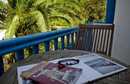 Matina Hotel, Mykonos Town. Balcony view from a gay-friendly hotel near gay bars. Relaxing with a book. Affordable price, perfect for gay travel.