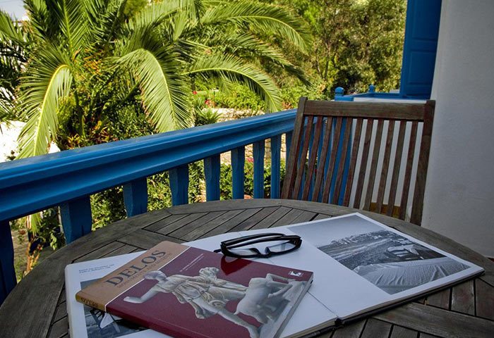 Matina Hotel, Mykonos Town. Balcony view from a gay-friendly hotel near gay bars. Relaxing with a book. Affordable price, perfect for gay travel.