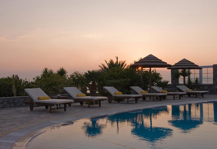 Marisso Hotel pool view in Mykonos Town. Find cheap price at this gay hotel with sunbeds, umbrellas, and a sunset. Relaxing vacation.