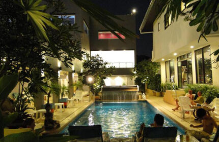 Sansuk Sauna & Guesthouse pool at night. Gay hotel in Pattaya, Thailand. Exclusive gay sauna with men relaxing by the pool.