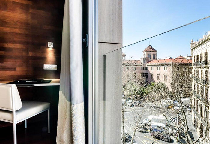View from Sansi Diputacio Hotel, a popular gay hotel in Barcelona's Eixample gayborhood. Room interior with city view. Gay travel advice.