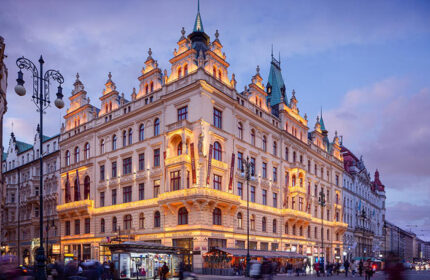 Hotel Kings Court, a gay-friendly hotel in Prague's Old Town City Center. The luxury hotel's exterior is illuminated at dusk.