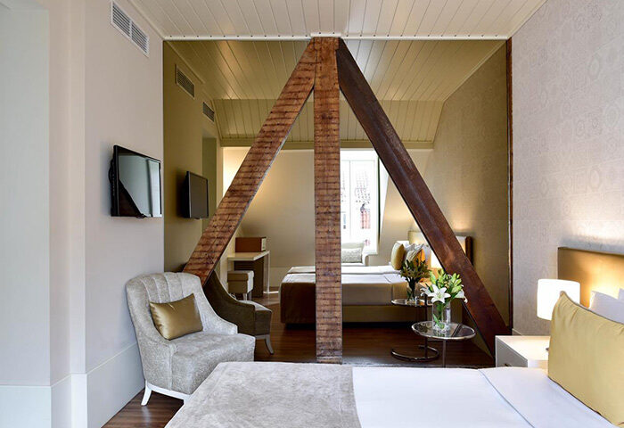 My Story Hotel Ouro room in Lisbon's gayborhood. Find last minute deals for this cheap city center hotel. Unique architecture, cozy beds, and TV.