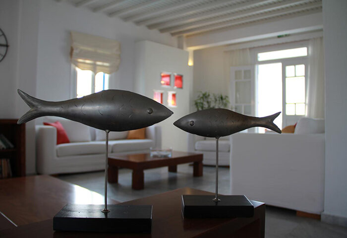 Marisso Hotel's decor in Mykonos Town. Two metal fish sculptures in a room of this cheap price gay hotel in Mykonos City Center.