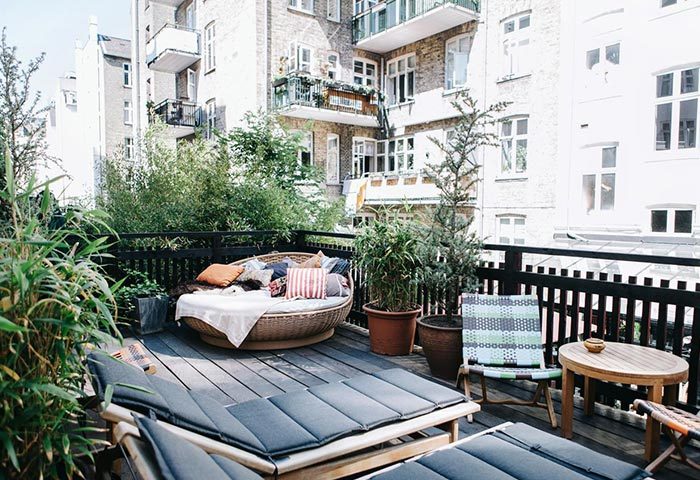 Axel Guldsmeden Hotel in Copenhagen balcony view. Find last minute cheap gay hotel deals. Relaxing outdoor space with plants and daybeds.