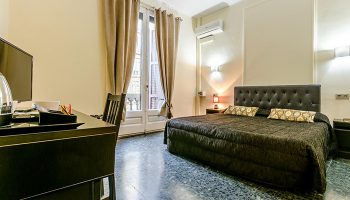 Hotel Victoria Palace, Barcelona room. Last minute deals for gay travelers in city center. Comfortable bed, desk, balcony.
