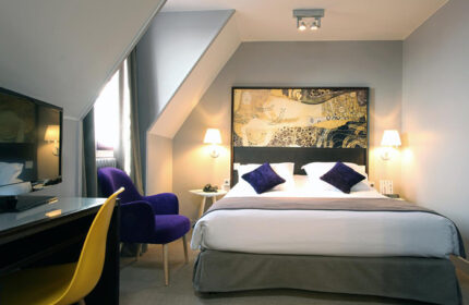 Little Palace Hotel room in Paris city center. Gay-friendly hotel with a bed, desk, chair, and modern decor. Find last minute deals!