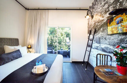 Dizengoff Avenue Boutique Hotel room. Find rooms for 3 people in Hilton Beach, Tel Aviv Gayborhood. Balcony view. Modern decor.