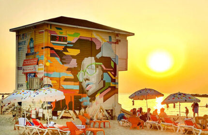Tel Aviv's Hilton Gay Beach lifeguard tower art at sunset. Find apartments near this popular gay travel spot. Two-bedroom penthouse rentals.
