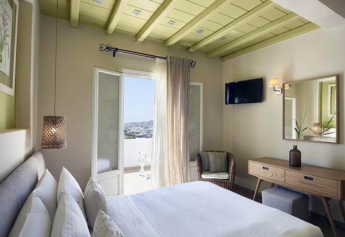 Vencia Boutique Hotel room in Mykonos Town. Find great deals on best gay hotels. Balcony view, modern decor, and comfortable bed. Mykonos travel.