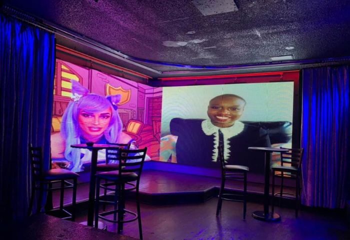 Flex Cocktail Lounge in Las Vegas. Interior view with screens showing digital drag queens. Gay bar scene, nightlife, travel advice.