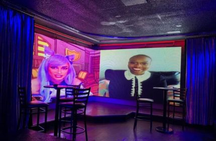 Flex Cocktail Lounge in Las Vegas. Interior view with screens showing digital drag queens. Gay bar scene, nightlife, travel advice.