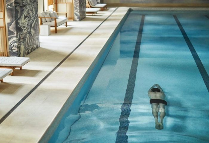 Four Seasons Hotel New York Downtown pool. Man swims laps in luxury hotel pool in Greenwich, a gay-friendly neighborhood.