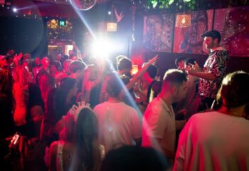 Francesca's Bar Melbourne: A lively gay bar scene with a diverse crowd dancing under disco lights. A popular spot for gay men's travel in Australia.