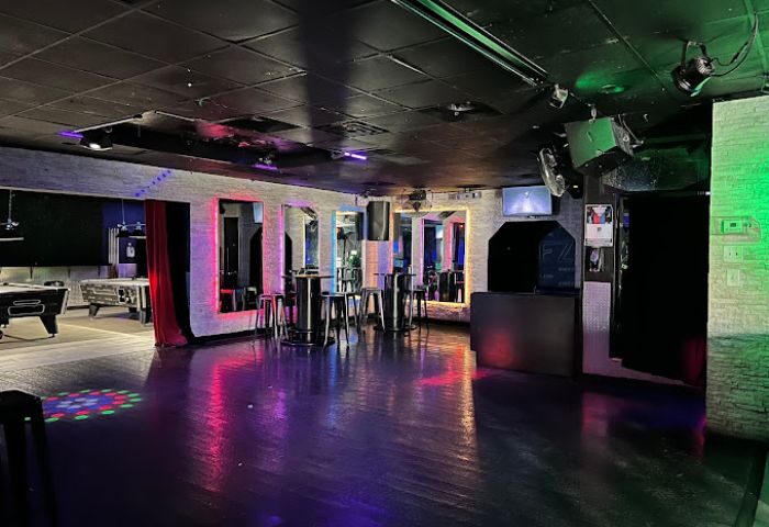 Interior of FreeZone Gay Bar in Las Vegas. Pool tables, bar stools, tables, mirrors, and colorful lighting. Gay travel destination.
