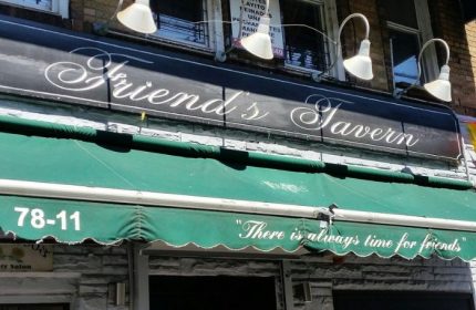 Friend's Tavern in New York. A gay-friendly bar with a welcoming vibe. There is always time for friends is written on the green awning.