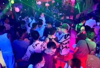 Frolic Bar, Ho Chi Minh City. Crowded gay bar scene with men socializing under colorful lights. Gay travel nightlife in Vietnam.