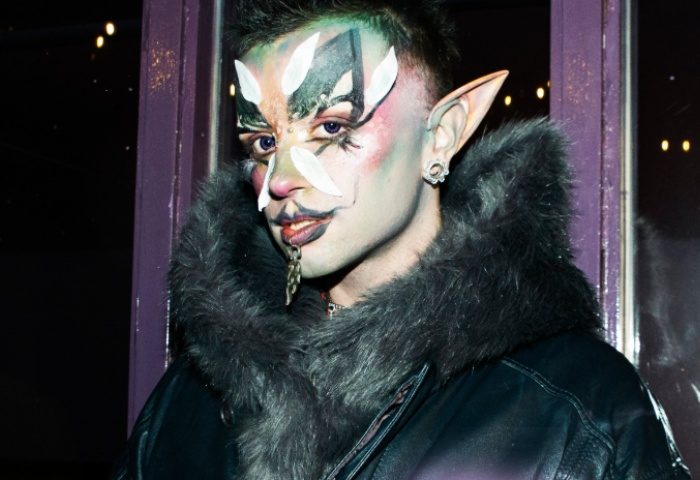 A drag queen with elf ears and face paint at G-A-Y Manchester. Nightlife fashion for gay men traveling in the UK. Queer scene.