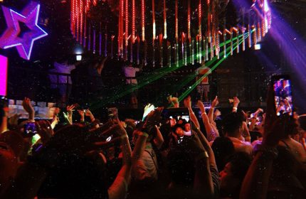 G Star Club Taipei: A packed dance floor at this popular gay club. People are dancing, with hands up, illuminated by club lights.