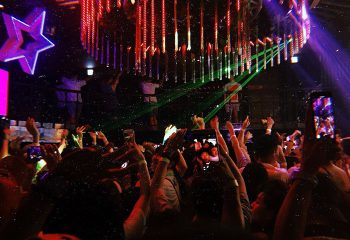 G Star Club Taipei: A packed dance floor at this popular gay club. People are dancing, with hands up, illuminated by club lights.