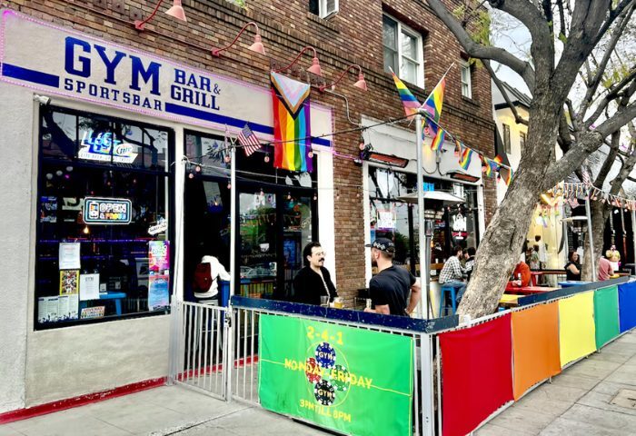 GYM Sportsbar NYC in New York. A gay bar with rainbow flags, outdoor seating, and a lively atmosphere. Gay travel destination.