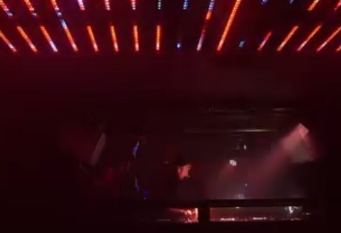 Gag Cph Copenhagen: Interior view of a gay bar in Copenhagen, Denmark. Red lights and a DJ booth create a vibrant atmosphere.