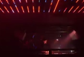 Gag Cph Copenhagen: Interior view of a gay bar in Copenhagen, Denmark. Red lights and a DJ booth create a vibrant atmosphere.