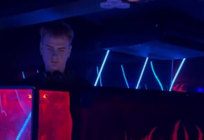 Gag-Cph-Copenhagen: DJ at Copenhagen gay club. Nightlife scene with blue and red lights. Gay travel advice in Copenhagen, Denmark.