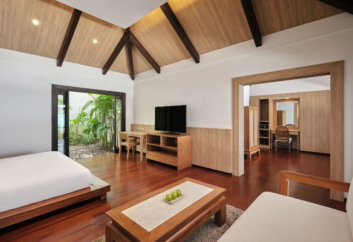 Garrya Tongsai Bay Samui suite interior. Best gay private beach hotel with modern design, wood accents, and lush garden view. Luxury travel.