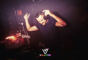 DJ at Village Soho, a gay dance bar in London. Live DJ playing music, creating a vibrant atmosphere. Nightlife in Soho for gay men.