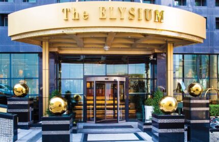 Elysium Taksim Hotel entrance. Gay-friendly hotel with revolving doors, gold accents, and modern design. A top choice for gay travelers.