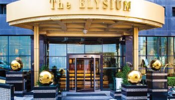 Elysium Taksim Hotel entrance. Gay-friendly hotel with revolving doors, gold accents, and modern design. A top choice for gay travelers.