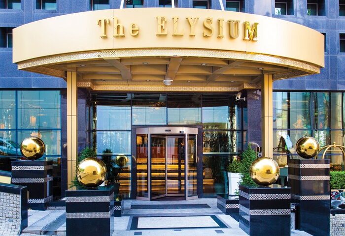 Elysium Taksim Hotel entrance. Gay-friendly hotel with revolving doors, gold accents, and modern design. A top choice for gay travelers.