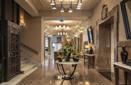 The Bank Hotel Istanbul lobby. Gay-friendly Design Hotel with luxury interior, marble floors, flower arrangement, and ornate elevator.