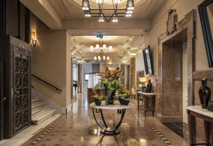 The Bank Hotel Istanbul lobby. Gay-friendly Design Hotel with luxury interior, marble floors, flower arrangement, and ornate elevator.