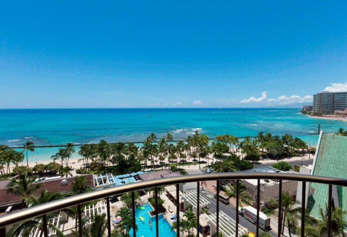 Waikiki Beach Marriott Resort view. Gay-friendly hotel balcony overlooking the ocean, palm trees, pool. Perfect for gay travel in Hawaii.