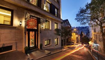 The Fox Hotel, a gay-friendly hotel. Exterior view at dusk with street scene. A great choice for gay men travel advice.