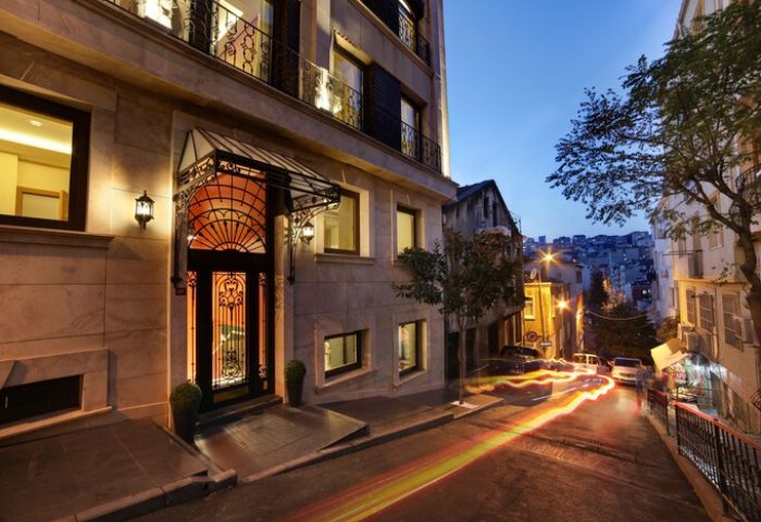 The Fox Hotel, a gay-friendly hotel. Exterior view at dusk with street scene. A great choice for gay men travel advice.
