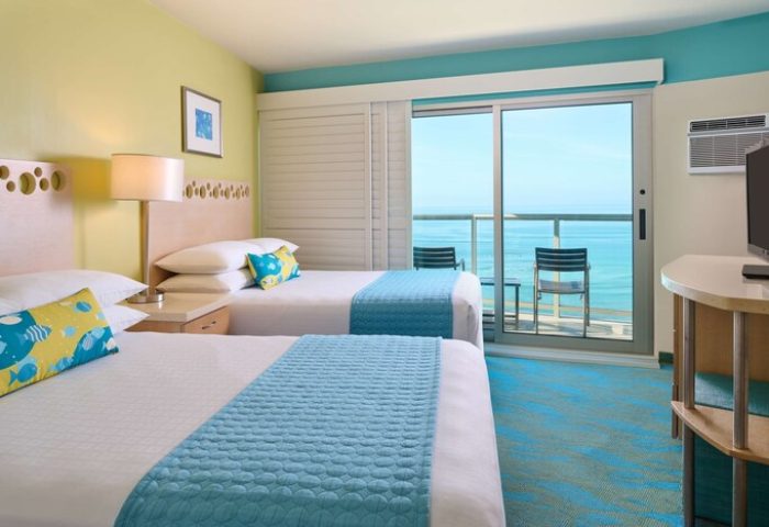Aston Waikiki Circle Hotel room with two beds and a balcony overlooking the ocean. Gay-friendly hotel with a view.